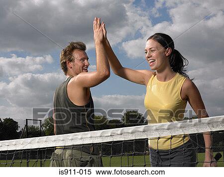 Tennis players doing a high five View Large Photo Image Stock Photography - Tennis players doing a high five. Fotosearch
