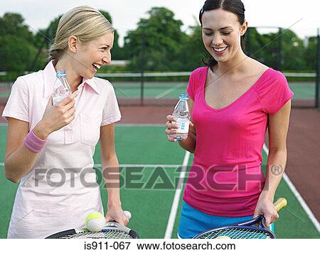 Stock Photo - Women having fun on tennis court. Fotosearch