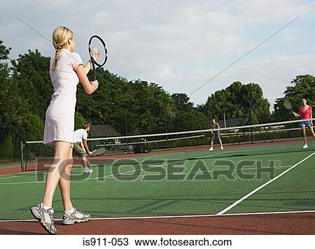 Young people playing tennis View Large Photo Image Stock Image - Young people playing tennis. Fotosearch