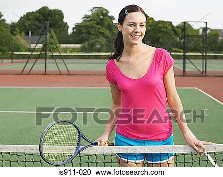 Young woman on a tennis court View Large Photo Image Stock Image - Young woman on a tennis court. Fotosearch