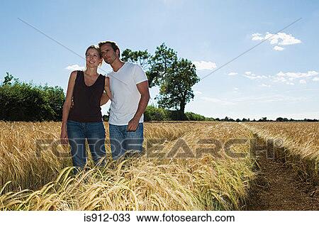 Couple in a field View Large Photo Image Stock Image - Couple in a field. Fotosearch