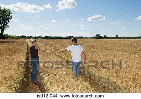 Couple in a wheat field View Large Photo Image Picture - Couple in a wheat field. Fotosearch