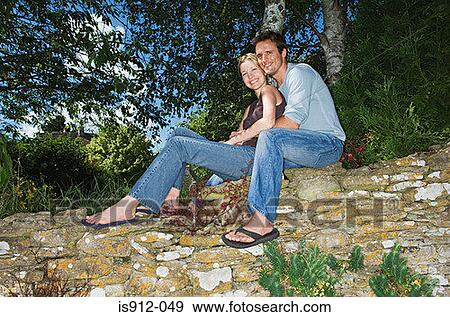Stock Photo - Couple on a stone wall. Fotosearch