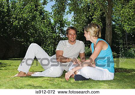 Couple sitting in a park View Large Photo Image Stock Image - Couple sitting in a park. Fotosearch