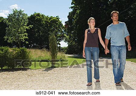 Couple walking around a park View Large Photo Image Stock Image - Couple walking around a park. Fotosearch