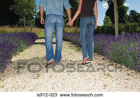 Couple walking on path holding hands View Large Photo Image Stock Image - Couple walking on path holding hands. Fotosearch