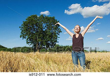 Happy woman in a field View Large Photo Image Stock Image - Happy woman in a field. Fotosearch