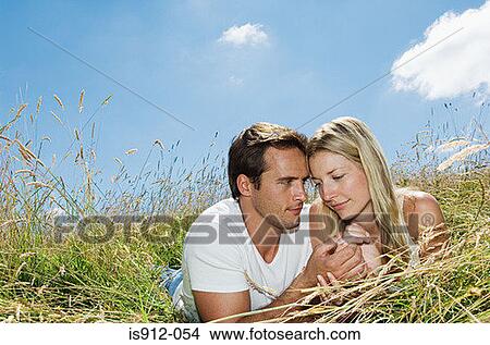 Loving couple in a field View Large Photo Image Picture - Loving couple in a field. Fotosearch