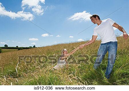 Man helping his girlfriend up View Large Photo Image Stock Photograph - Man helping his girlfriend up. Fotosearch