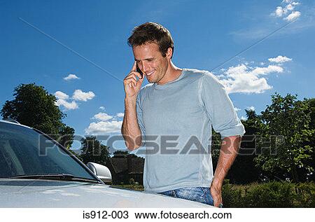 Man in mobile phone by his car View Large Photo Image Stock Image - Man in mobile phone by his car. Fotosearch