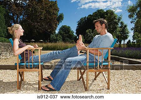Stock Photo - Man massaging his girlfriend's feet. Fotosearch