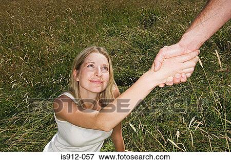 Woman being helped up View Large Photo Image Stock Photo - Woman being helped up. Fotosearch