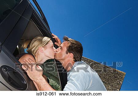 Woman in car kissing boyfriend View Large Photo Image Stock Image - Woman in car kissing boyfriend. Fotosearch
