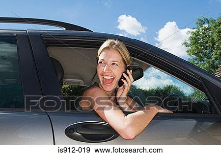 Woman in car using mobile phone View Large Photo Image Stock Photo - Woman in car using mobile phone. Fotosearch