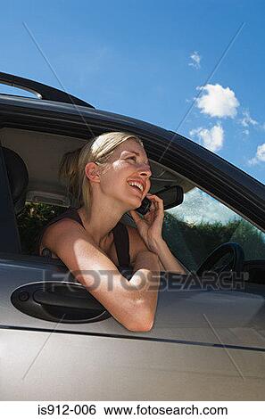Woman in car using mobile phone View Large Photo Image Stock Photograph - Woman in car using mobile phone . Fotosearch