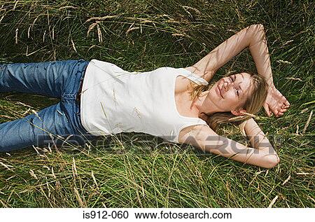 Woman lying in a field View Large Photo Image Stock Image - Woman lying in a field. Fotosearch