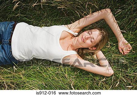 Stock Photograph - Woman sleeping in a field. Fotosearch