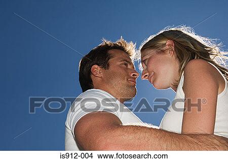 Young couple holding each other View Large Photo Image Picture - Young couple holding each other. Fotosearch