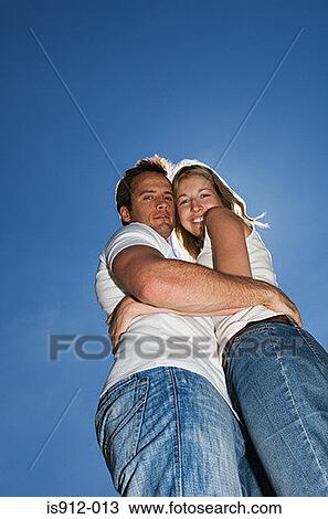 Stock Image - Young couple hugging. Fotosearch
