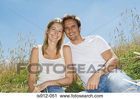 Stock Image - Young couple in a field. Fotosearch
