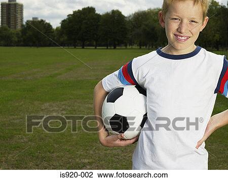 Boy holding a football View Large Photo Image Stock Image - Boy holding a football. Fotosearch