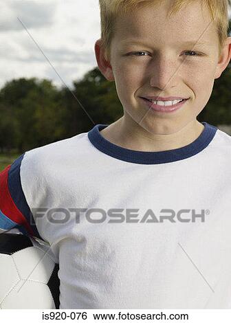 Stock Photograph - Boy holding a football. Fotosearch