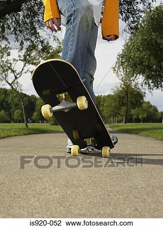 Boy skateboarding in a park View Large Photo Image Stock Image - Boy skateboarding in a park. Fotosearch