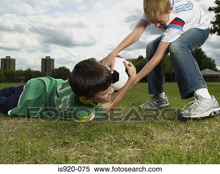 Boys fighting over a football View Large Photo Image Stock Photography - Boys fighting over a football. Fotosearch