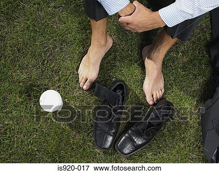 Businessman sitting on the grass View Large Photo Image Stock Photo - Businessman sitting on the grass. Fotosearch