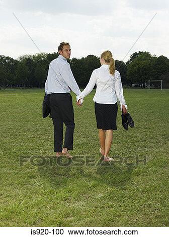 Stock Image - Couple leaving a park. Fotosearch