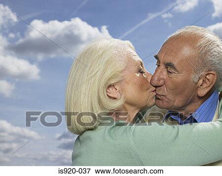 Stock Photo - Elderly couple kissing. Fotosearch