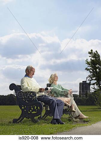 Elderly couple sitting in a park View Large Photo Image Stock Photo - Elderly couple sitting in a park. Fotosearch