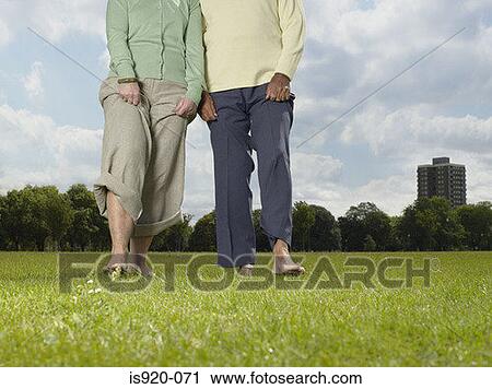 Elderly couple walking bare foot in the park View Large Photo Image Stock Image - Elderly couple walking bare foot in the park. Fotosearch