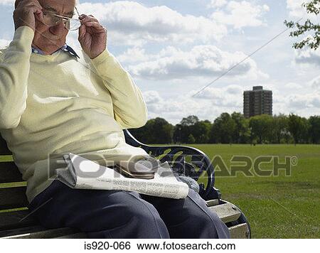 Stock Photograph - Elderly man reading a newspaper. Fotosearch