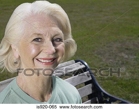 Elderly woman in a park View Large Photo Image Stock Photography - Elderly woman in a park. Fotosearch