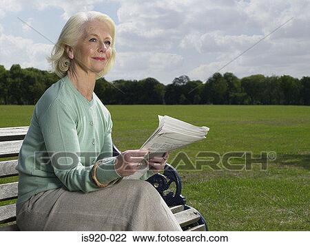 Elderly woman reading in a park View Large Photo Image Stock Image - Elderly woman reading in a park. Fotosearch