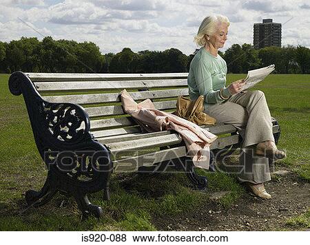 Elderly woman reading in a park View Large Photo Image Stock Photo - Elderly woman reading in a park. Fotosearch