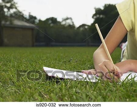 Girl doing homework in a park View Large Photo Image Stock Image - Girl doing homework in a park. Fotosearch