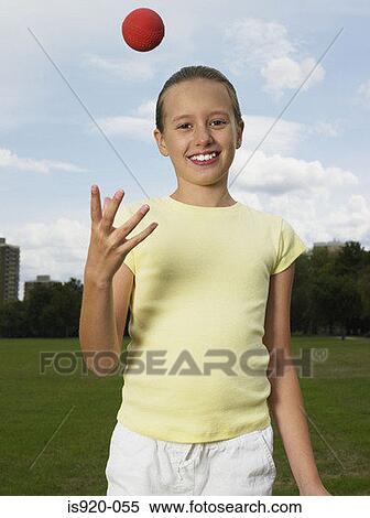 Girl throwing a ball View Large Photo Image Stock Photography - Girl throwing a ball. Fotosearch