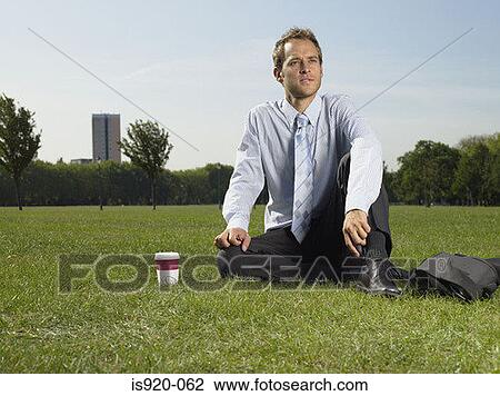 Male office worker sitting in the park View Large Photo Image Stock Image - Male office worker sitting in the park. Fotosearch
