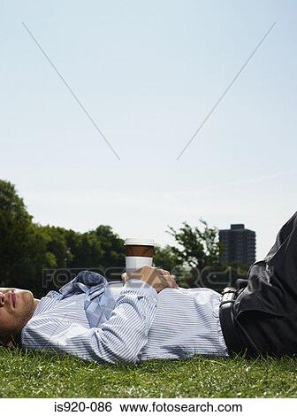 Male office worker sleeping in a park View Large Photo Image Stock Photograph - Male office worker sleeping in a park. Fotosearch