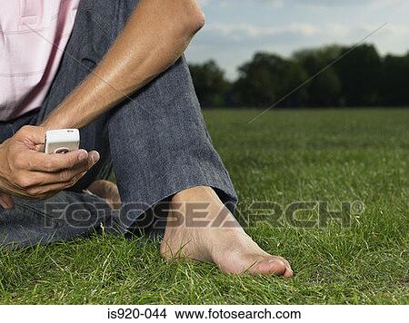 Man using a cellular telephone View Large Photo Image Picture - Man using a cellular telephone. Fotosearch