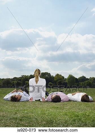 Office workers relaxing in a field View Large Photo Image Stock Image - Office workers relaxing in a field. Fotosearch