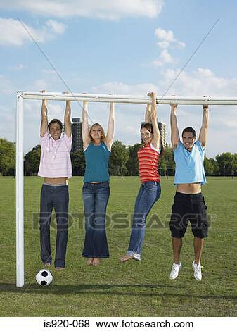 People hanging from a goal post View Large Photo Image Stock Photo - People hanging from a goal post. Fotosearch