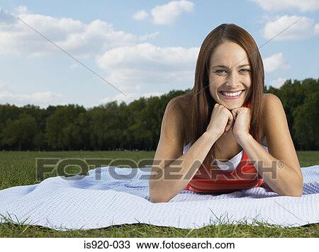 Woman lying in a field View Large Photo Image Stock Image - Woman lying in a field. Fotosearch