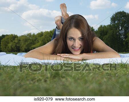 Stock Photo - Woman lying in a field. Fotosearch