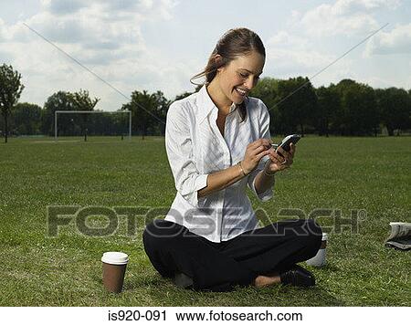 Woman using a handheld computer View Large Photo Image Stock Image - Woman using a handheld computer. Fotosearch