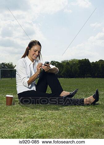 Woman using a handheld computer View Large Photo Image Stock Photography - Woman using a handheld computer. Fotosearch