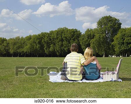 Stock Photograph - Young couple having a picnic in a park. Fotosearch