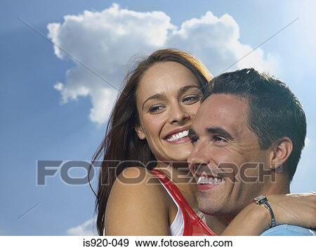 Stock Photo - Young couple hugging. Fotosearch